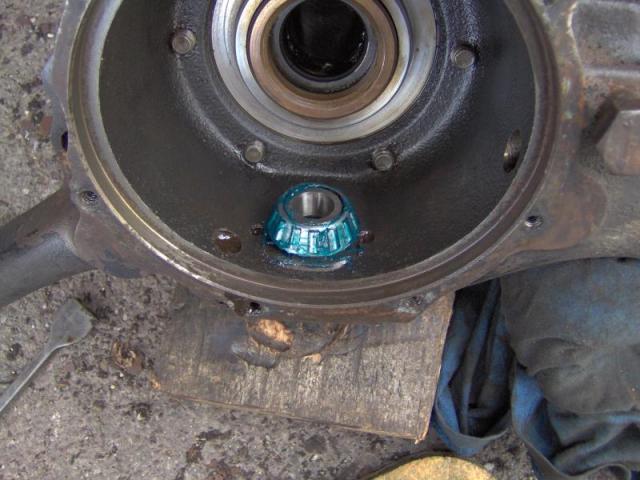 Feed the housing back over the driveshaft and hook the lower bearing into 